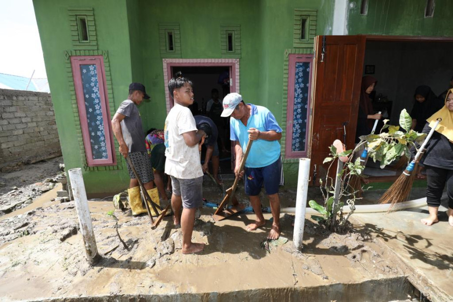 Warga bergotong-royong membersihkan lumpur dari rumah yang terdampak banjir bandang di Desa Torue, Kecamatan Torue, Kabupaten Parigi Moutong, Provinsi Sulawesi Tengah, Minggu (31/7).