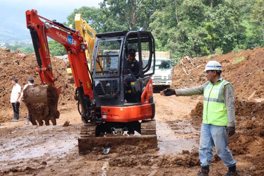 Salah satu arat berat yang digunakan untuk membuka jalan yang tertimbun longsor pascagempa Kabupaten Cianjur, Jawa Barat, Selasa (22/11).