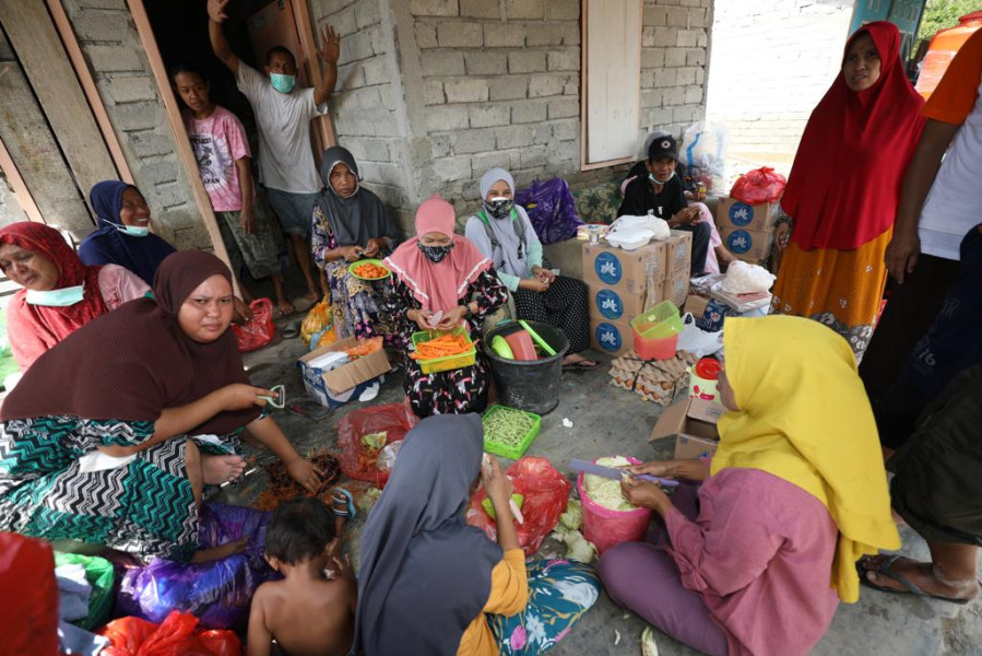 Sejumlah ibu rumah tangga memasak bersama di dapur umum darurat untuk memenuhi kebutuhan permakanan warga terdampak banjir bandang Desa Torue, Kecamatan Torue, Kabupaten Parigi Moutong, Provinsi Sulawesi Tengah, Minggu (31/7).